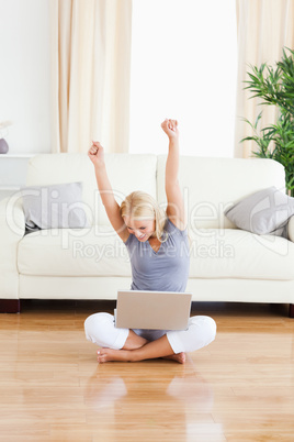 Portrait of a cheerful woman with a laptop while sitting on the