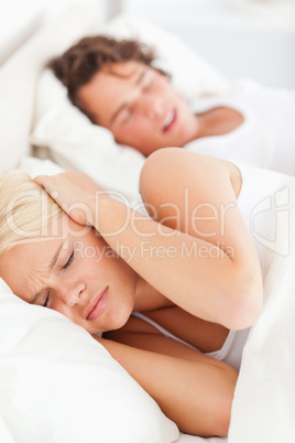 Portrait of a woman awaken by her boyfriend's snoring
