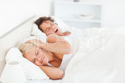 Annoyed woman awaken by her boyfriend's snoring