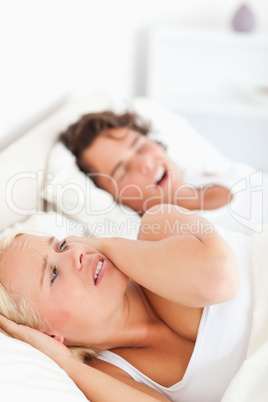 Portrait of an annoyed woman awaken by her fiance's snoring
