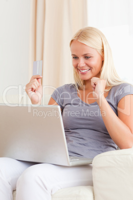 Portrait of a woman using her credit card to shop online