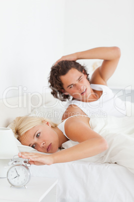 Portrait of a tired couple waking up