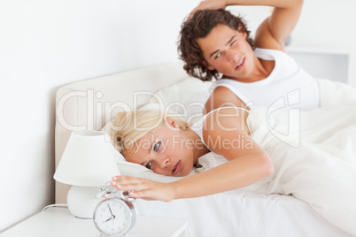 Tired couple waking up