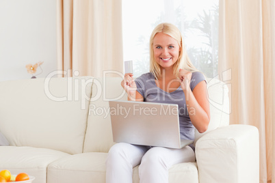 Woman cheering while buying online