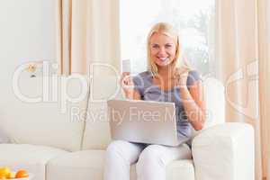 Woman cheering while buying online