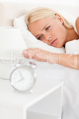 Portrait of a woman awaken by an alarmclock