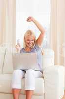 Portrait of a woman cheering while buying online