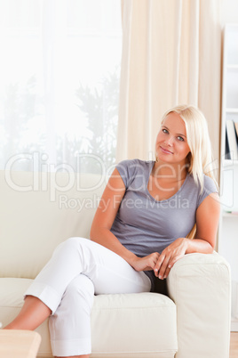 Blonde woman sitting on a sofa