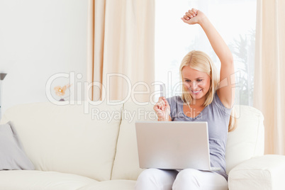 Smiling blonde woman buying online