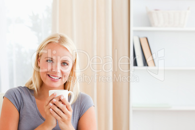 Woman sitting on a couch with a cup of tea