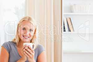 Woman sitting on a couch with a cup of tea