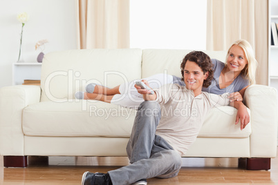 Laughing cute couple watching TV
