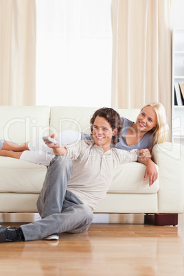 Portrait of a smiling couple watching TV