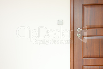 wooden door with a handle in a white room