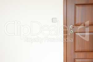 wooden door with a handle in a white room