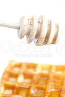 delicious Belgian waffles and stick to honey isolated on white