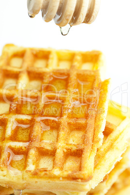 delicious Belgian waffles and stick to honey isolated on white