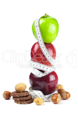 apple, nuts, cookies and measure  tape isolated on white