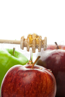 stick to honey and apples isolated on white