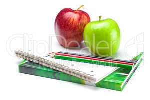 apple, notebooks and pencils isolated on white