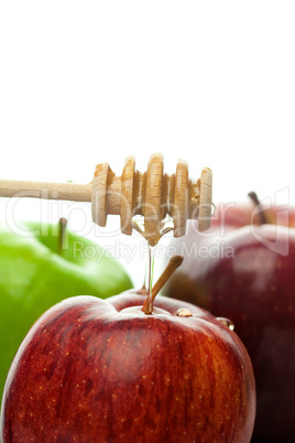 stick to honey and apples isolated on white