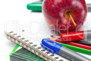 apple, notebooks and pencils isolated on white