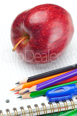 apple, notebooks and pencils isolated on white