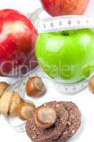 apple, nuts, cookies and measure  tape isolated on white