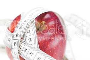 apple and measure tape isolated on white