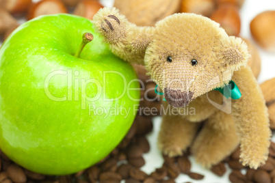 teddy bear with a bow,apple, coffee beans and nuts