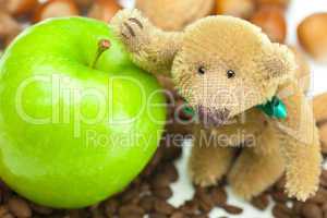 teddy bear with a bow,apple, coffee beans and nuts