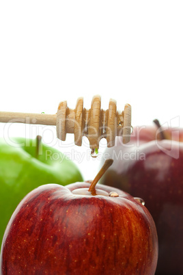 stick to honey and apples isolated on white