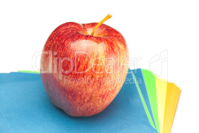 apple and colored paper  isolated on white