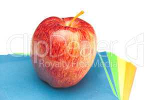 apple and colored paper  isolated on white