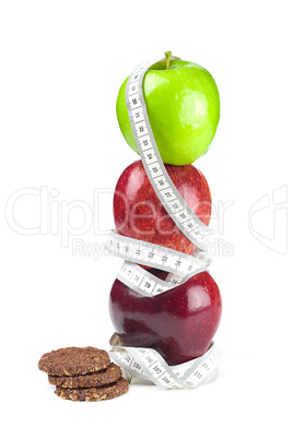 apple, cookies and measure  tape isolated on white