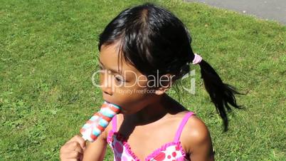 Little Girl Enjoying A Popsicle