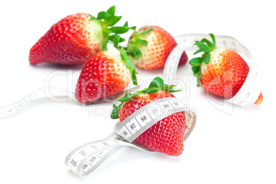 big juicy red ripe strawberries and measure tape isolated on whi