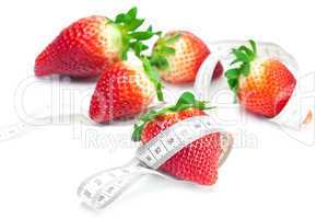 big juicy red ripe strawberries and measure tape isolated on whi
