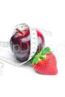 big juicy red ripe strawberries,apple and measure tape isolated