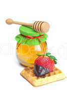 big juicy ripe strawberries in chocolate, a jar of honey and waf
