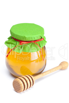 stick to hohey  and  jar of honey  isolated on white