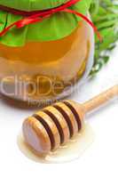 stick to hohey  and  jar of honey  isolated on white
