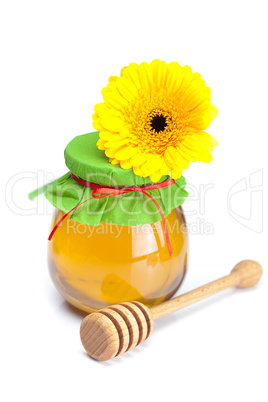 stick to hohey ,flower  and  jar of honey  isolated on white