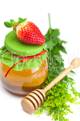 big juicy ripe strawberries and  jar of honey  isolated on white