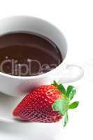 melted chocolate in a bowl and strawberries isolated on white
