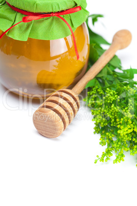 stick to hohey and  jar of honey  isolated on white