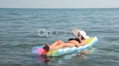 Female lying on  inflatable float