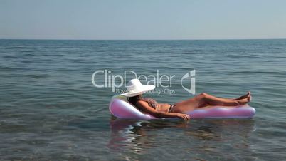 Relaxed girl wearing a white hat on float