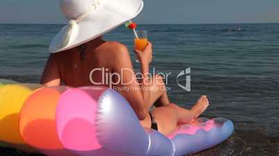 woman sunbathing  with cocktail