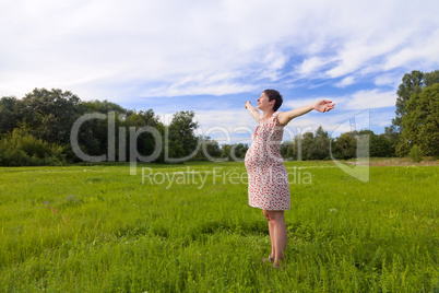 Pregnant woman with closed eyes and open hands